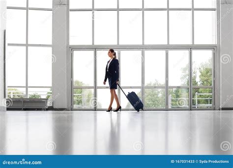 Businesswoman With Travel Bag Walking Along Office Stock Image Image