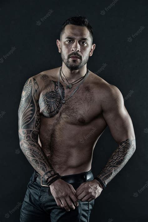 Premium Photo Bearded Man With Tattooed Body Man With Sexy Bare Torso In Jeans Tattoo Model