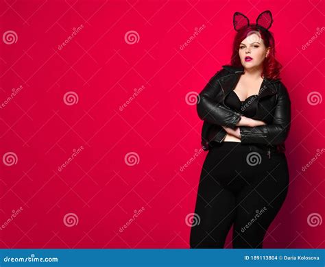 Cute Plus Size Brunette With Black Bunny Ears In Leather Jacket And Underwear Posing On Red