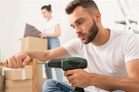 Premium Photo Concentrated Young Bearded Man Assembling Furniture