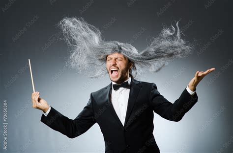 Funny conductor with long grey hair Stock Photo | Adobe Stock