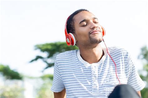 Free Photo Relaxed Young Man Loving Music Enjoying Nature