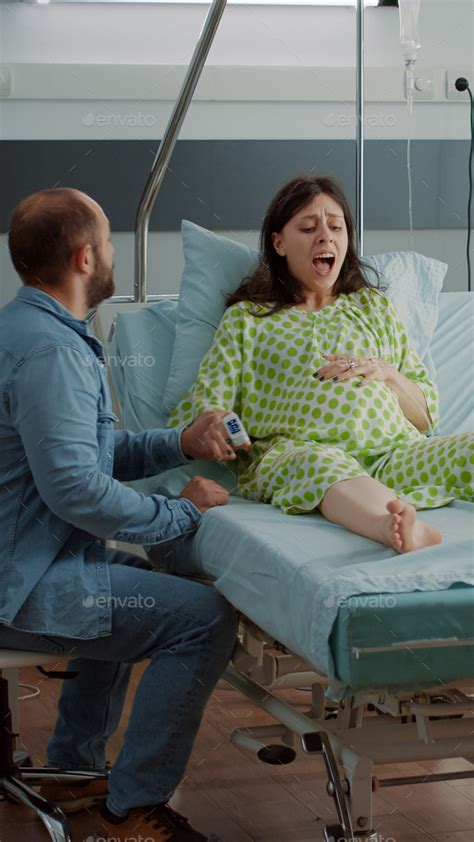 Screaming Pregnant Woman Going Into Labor In Hospital Ward Stock Photo