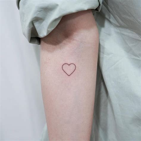 Minimalistic Heart Tattoo Located On The Inner Forearm