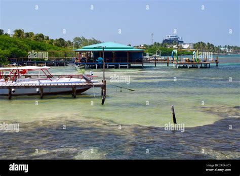 A Bar Over The Water Some Boats And Buildings In The Background In