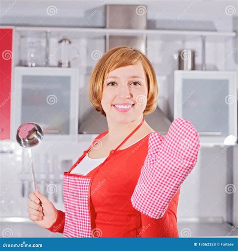 Belle Jeune Femme Au Foyer Dans La Poche De Fixation De Cuisine Photo