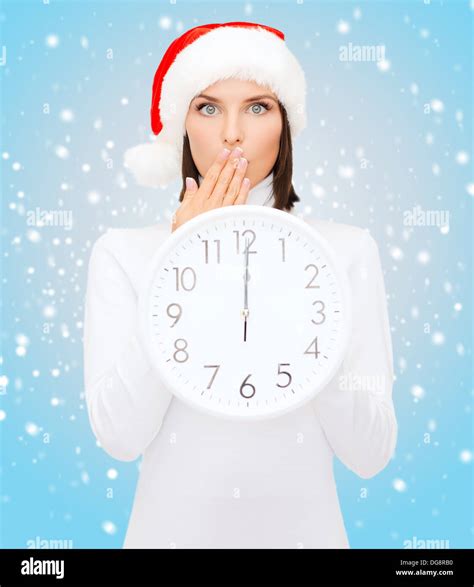 Woman In Santa Helper Hat With Clock Showing 12 Stock Photo Alamy