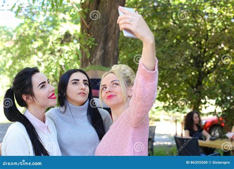 Three Wonderful Young Girl Girlfriends Make Selfie Photo On Pho Stock