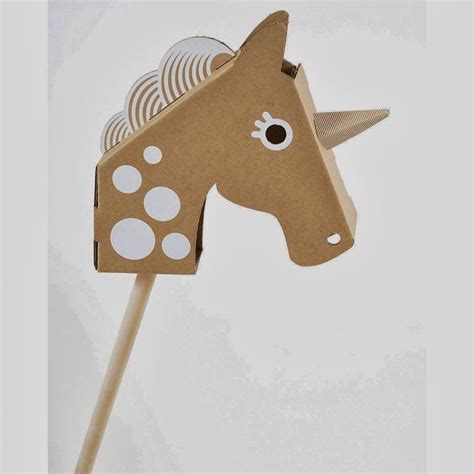 A Wooden Toy Horse With Polka Dots On Its Head And Tail Made Out Of