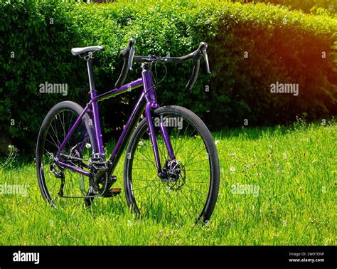 Gravel Bicycle On Green Grass In The Park Bicycle Close Up Stock Photo