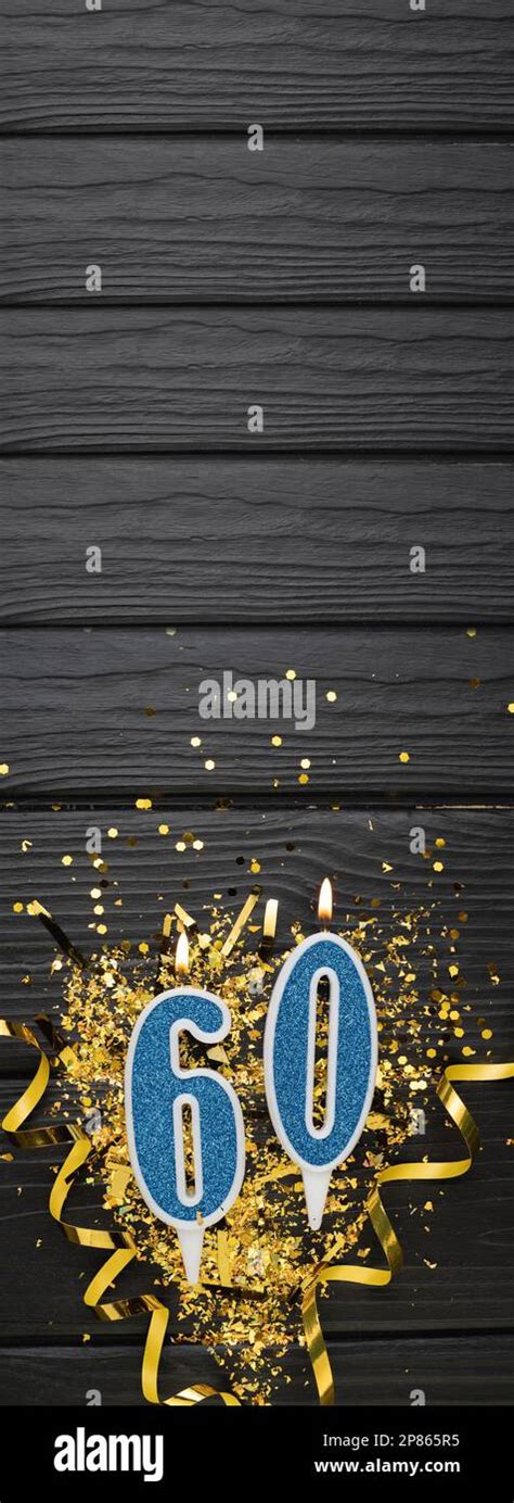 Number 60 Blue Celebration Candle And Gold Confetti On Dark Wooden