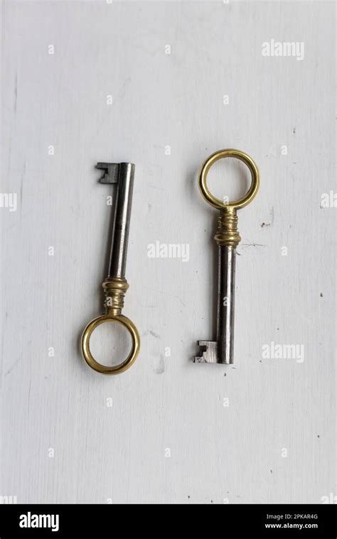 Two Identical Keys On A White Wooden Table Stock Photo Alamy