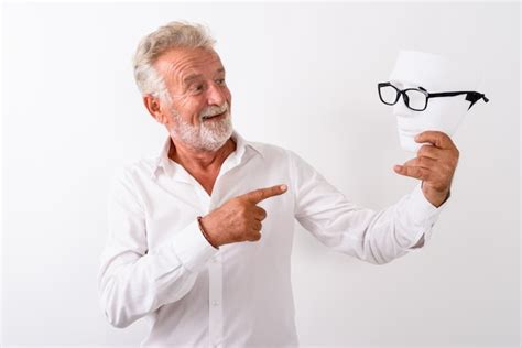 Premium Photo Happy Senior Bearded Man Smiling While Holding And