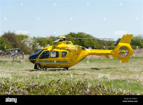 The East Anglia Air Ambulance Helicopter In A Field In Cambridgeshire