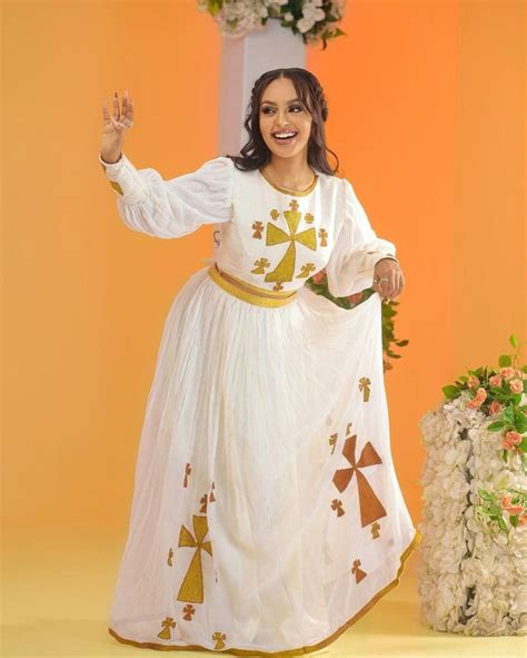 Majestic Habesha Kemis With A Vibrant Tilf Design And A Mix Of Menen