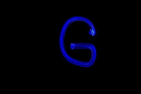 Light Painting Blue Letter G On Black Background Stock Photo Download