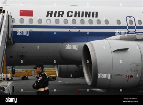 FILE A Chinese Ground Crew Member Walks Past An Airbus Jet Plane Of