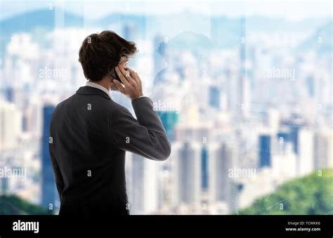 Business Man Next To The Window Talking With Cell Phone Stock Photo Alamy