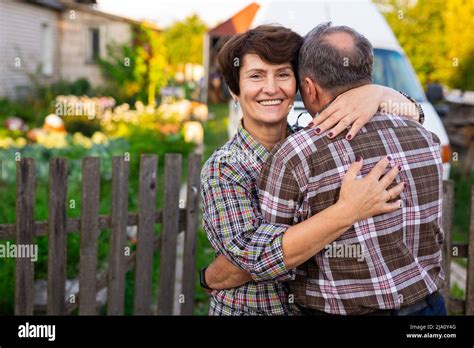 Mature Happy Man And Woman Hugging At The Infield Near The Fence Stock