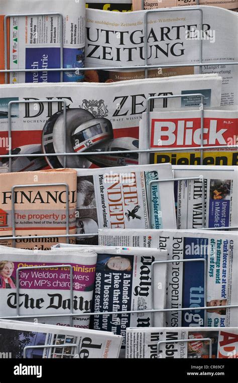 German and English newspapers in a newspaper display stand Stock Photo ...