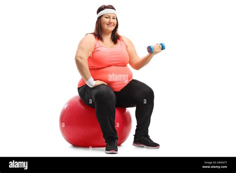 Overweight Woman Sitting On An Exercise Ball And Exercising With A