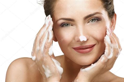 Beautiful Woman Cleaning Her Face With A Foam Treatment Stock Photo