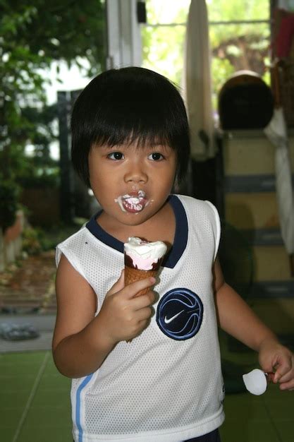 Premium Photo Cute Boy Eating Ice Cream