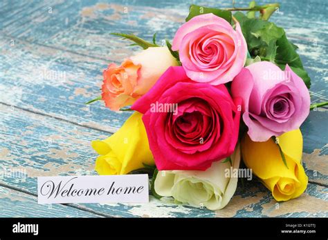 Welcome Home Card With Colorful Rose Bouquet On Rustic Wooden Surface