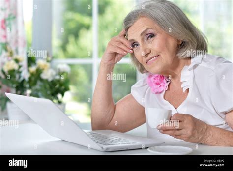 Portrait Of A Mature Woman Sitting With Modern Laptop Stock Photo Alamy