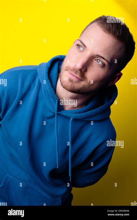 Handsome Joyful Male Model Look To Side While Lean Over With His Top
