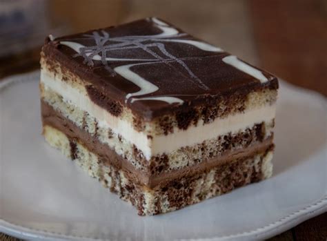 A Piece Of Cake On A Plate With Chocolate And White Frosting In The Middle