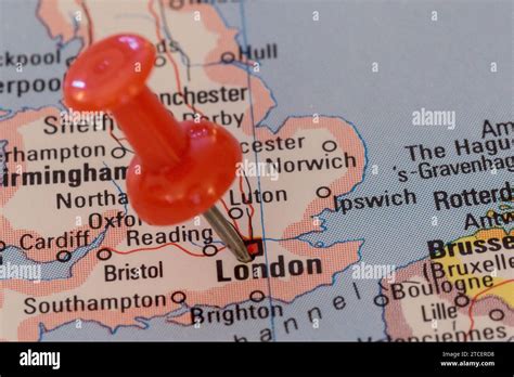 A Red Pin Stuck Into A Map Of Western Europe Pinpointing The Location