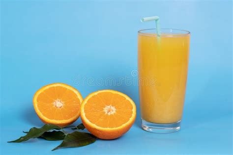 Zumo De Naranja Natural En Un Vaso Con Fruta Cortada A La Mitad Y