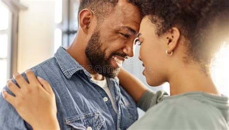 Young Happy Mixed Race Couple Hugging While Relaxing At Home Cozy