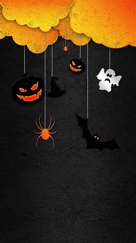 Halloween Background With Pumpkins And Bats Hanging From Strings