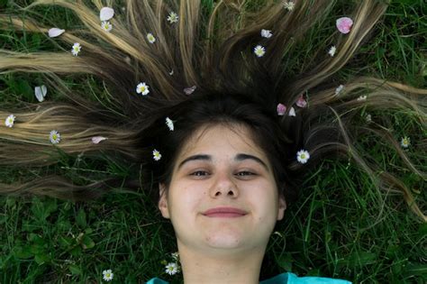 Premium Photo Portrait Of Young Woman Lying On Grass