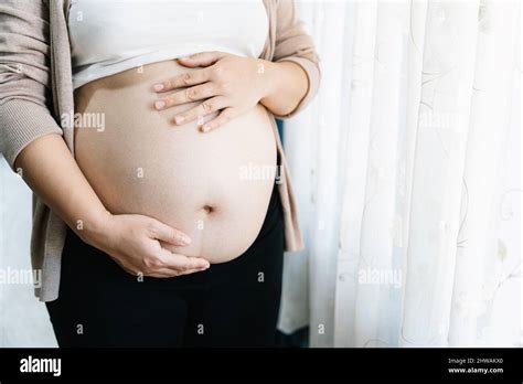 Pregnant Woman With Big Belly At Window Pregnancy Motherhood People