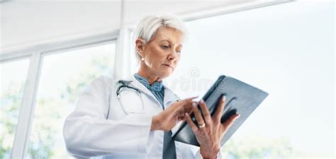 Hospital Mature Doctor And Tablet For Research On Medical Treatment