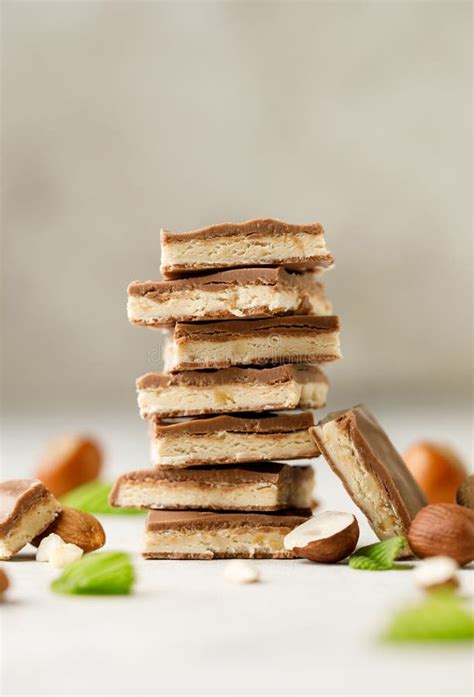 Chocolate Pieces On White Background With Hazelnut Stack Of Chocolate