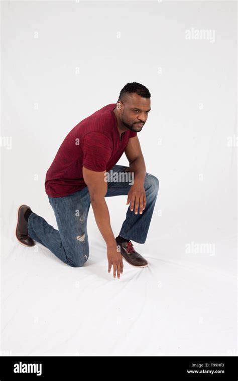 Thoughtful Black Man Kneeling Stock Photo Alamy