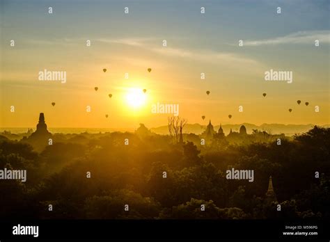Hot Air Balloons Flying Over The Pagodas Of Bagan And The Foggy Plains Of The Archaeological