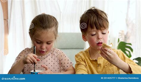 Hermana Y Hermano Disfrutan Comiendo Deliciosos Helados En La Cocina