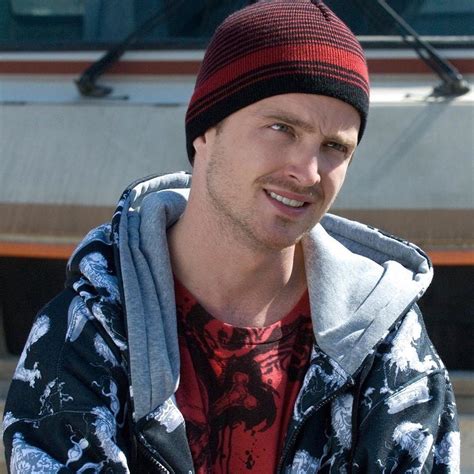 A Man Wearing A Red And Black Beanie