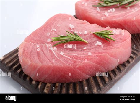 Raw Tuna Fillets With Salt And Rosemary Isolated On White Stock Photo