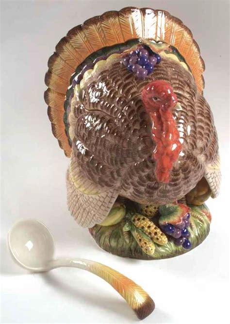 A Turkey Figurine Sitting Next To A Spoon