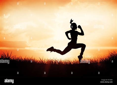 Composite Image Of Fit Brunette Running And Jumping Stock Photo Alamy