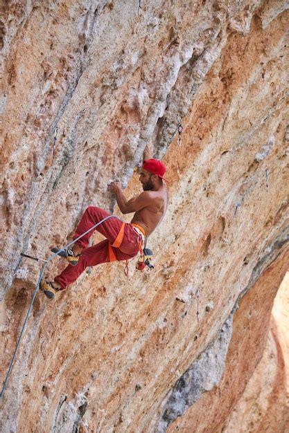 Premium Photo Full Body Side View Of Strong Alpinist With Naked Torso