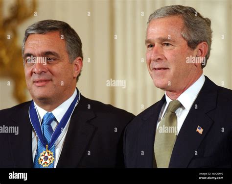 U.S. President George W. Bush stands with former CIA Director George Tenet after Bush awarded ...