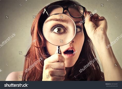 Shocked Woman Looking Through A Magnifying Glass Stock Photo 335742491