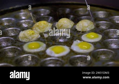 Slow Motion Of Stall Vendor Roasting Quail Eggs On Stove In Food Stand